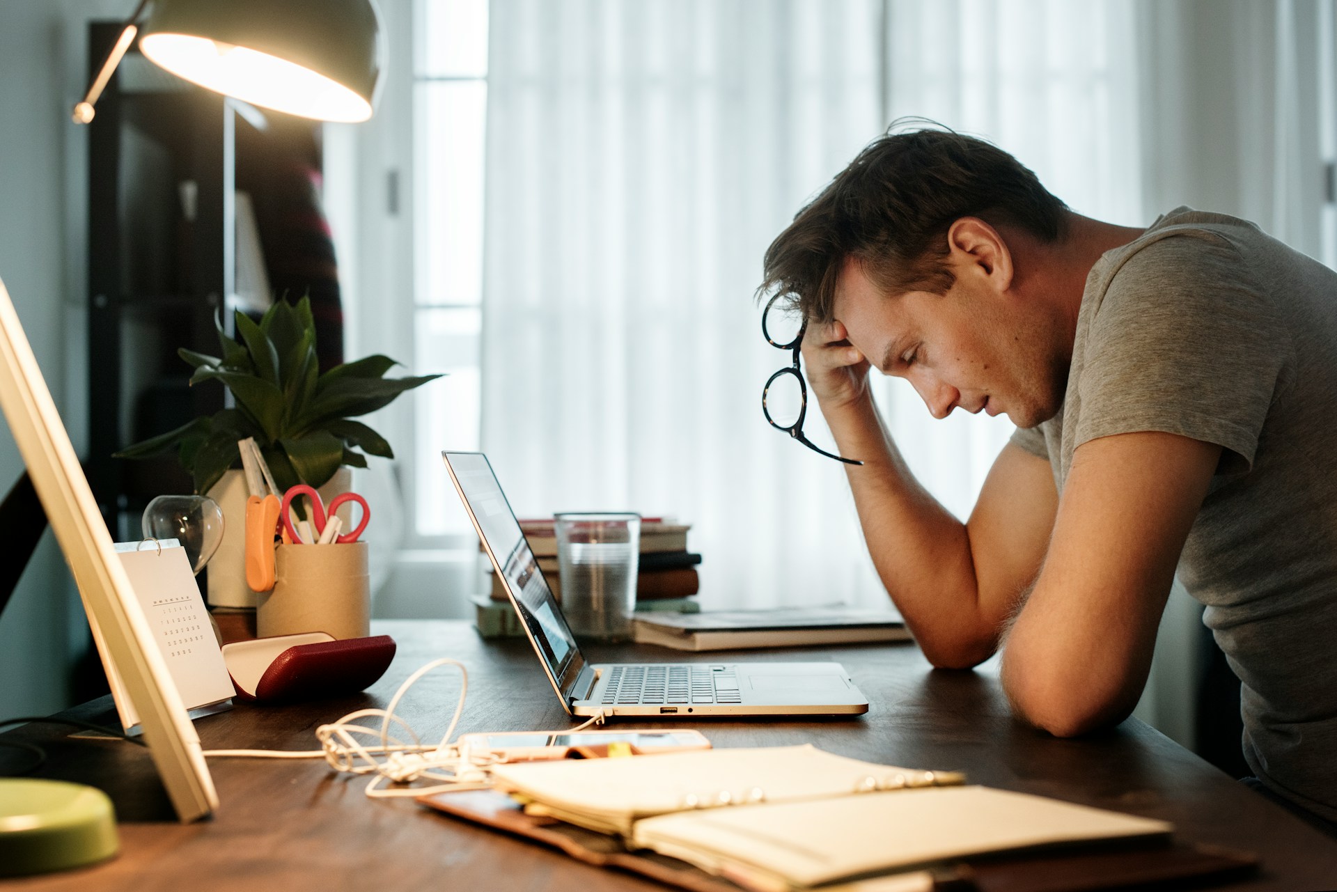 Home service contractor reviewing customer data on a laptop — the manual review-asking work ReviewWheel automates.